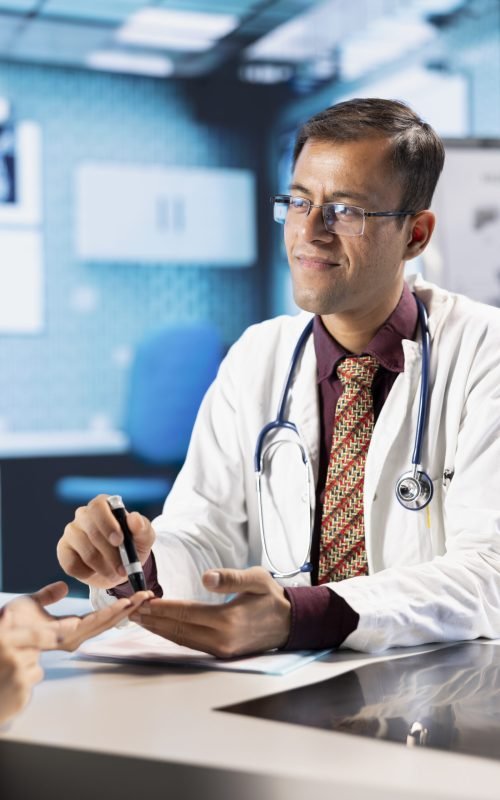 Medical consultation with physician using an insulin injector for a patient suffering from diabetes, diagnostics and treatment. Indian doctor using insulin pen in a modern healthcare facility.
