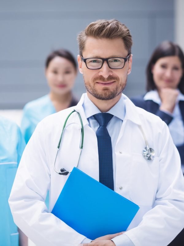Portrait of smiling doctors standing together in hospital premises